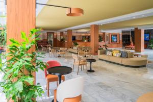 a lobby with couches and tables and chairs at Hacienda San Jorge in Breña Baja