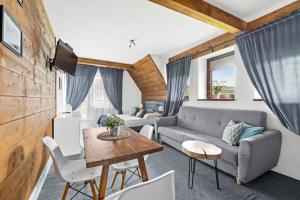 - un salon avec un canapé et une table dans l'établissement Villa 307 Spisz Resort, à Jurgów