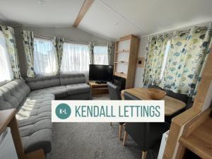 a living room with a couch and a table at Willerby (Green Lawns) in Selsey