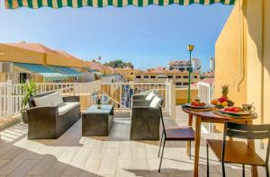 a patio with a table and chairs on a balcony at Cosy Mareverde FREE WIFI in Adeje