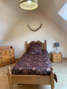 a bedroom with a bed and two night stands at Agréable maison meublée in Cherbourg en Cotentin