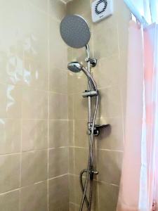 a shower with a shower head in a bathroom at The Quiet Room in Newcastle upon Tyne