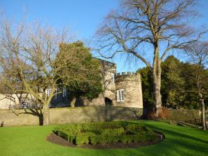 an old castle with a garden in front of it at 28 Water Street in Skipton