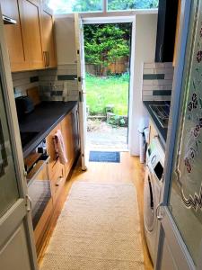 a kitchen with a refrigerator and a door to a yard at The Quiet Room in Newcastle upon Tyne