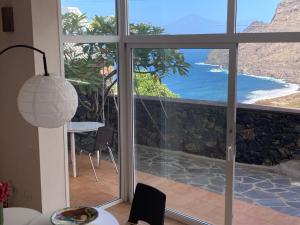 a room with a large window with a view of the ocean at Casa Julietta in Hermigua