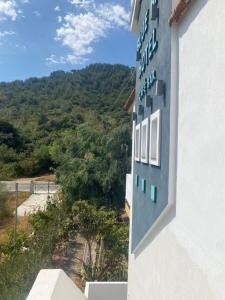 a sign on the side of a building with a mountain in the background at Blue Bay Beach Hotel in Koinyra