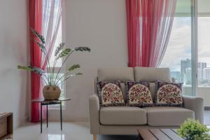 a living room with a couch and a window at New l B5 Near KLCC Peranakan Home 15px in Kuala Lumpur