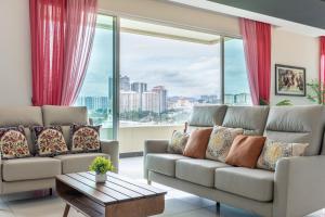 a living room with couches and a large window at New l B5 Near KLCC Peranakan Home 15px in Kuala Lumpur