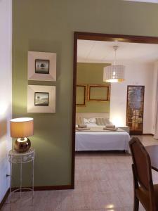 a bedroom with a bed and a table and a mirror at Giove Rooms in Verona