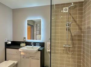 a bathroom with a shower and a sink and a shower at Grange Farm Park in Alford