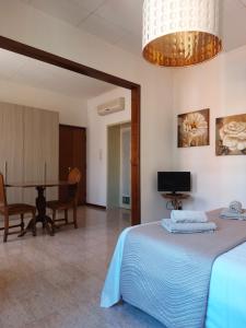 a bedroom with a bed and a dining room at Giove Rooms in Verona