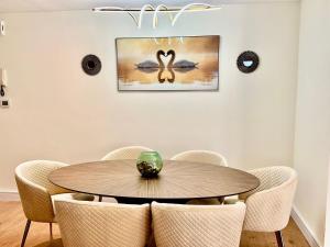 a dining room with a wooden table and chairs at 2BR Luxury Apartment Marina View in Dubai
