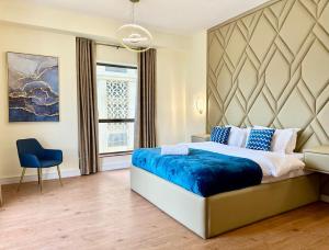 a bedroom with a large bed and a blue blanket at 2BR Luxury Apartment Marina View in Dubai