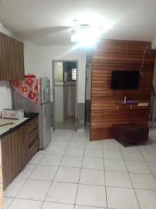 a kitchen with a tv on a wall and a kitchen with at Sky Chalet at Axis Next To LRT Pandan Indah Ampang in Ampang