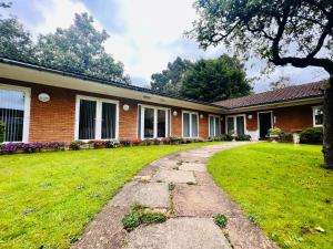 a brick house with a grass yard at Selborne studios - Breakfast Included in Parkside