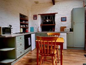 a kitchen with a table and two chairs in it at The Horseshoe in Lochgilphead