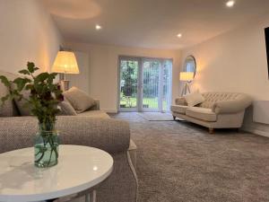 a living room with a couch and a table at Selborne Studios Off road gated parking in Parkside