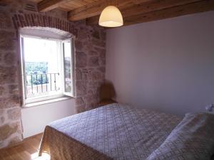 a bedroom with a bed and a window at Apartments Antica Orsera in Vrsar