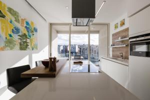 a kitchen with a table and a view of a city at Splendid Seaside Retreat on Spinola Bay in St. Julianʼs