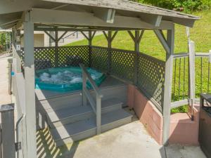 a gazebo with a hot tub under it at Carr's Northside Hotel and Cottages in Gatlinburg
