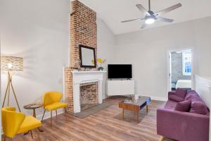 a living room with a couch and a fireplace at Stars on State in the Heart of Downtown Historic District in Mobile