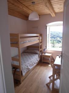 a bedroom with two bunk beds and a window at Apartments Antica Orsera in Vrsar