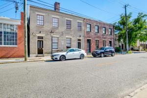 two cars parked on a street in front of a building at Stars on State in the Heart of Downtown Historic District in Mobile