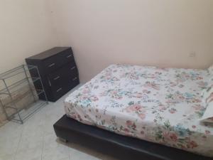 a bedroom with a bed and a dresser at Appartement Sidi Maarouf in Casablanca