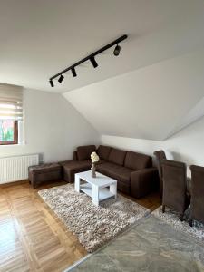 a living room with a couch and a table at Apartmani Ristanović in Zlatibor