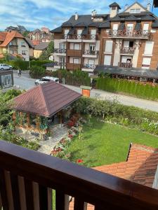 a view from the balcony of a building with a garden at Apartmani Ristanović in Zlatibor