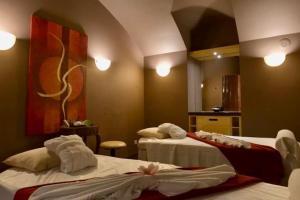 プラハにあるル パレ アート ホテル プラハのベッド2台と鏡が備わるホテルルームです。