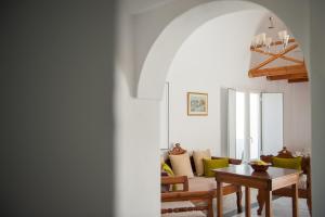 a living room with a table and a couch at Altea Apartments in Fira