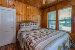 a bedroom with a bed in a wooden cabin at Carr's Northside Hotel and Cottages in Gatlinburg
