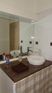 a bathroom with a sink and a mirror at Studio Maison Fyot in Dijon