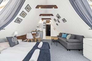 a room with a bed and a couch and a table at Villa 307 Spisz Resort in Jurgów +104 photos