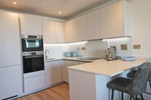 a kitchen with white cabinets and a counter top at Sea view apartment, first floor in Saint Merryn +27 photos