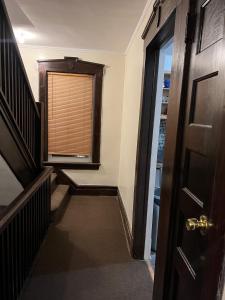 korytarz z drzwiami i oknem w obiekcie Victorian Palace- Mahogany Room w mieście East Orange
