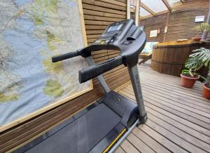 a treadmill on a deck next to a map at Cabañas Cerca del Centro in Puerto Montt