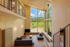 a living room with a couch and a large window at Hupni Rusutsu in Rusutsu