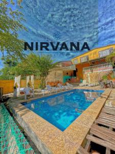 a swimming pool in front of a hotel at Hostel Nirvana San Gil in San Gil