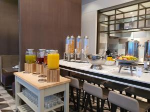 a bar with chairs and drinks on a counter at Hilton Aberdeen TECA in Aberdeen