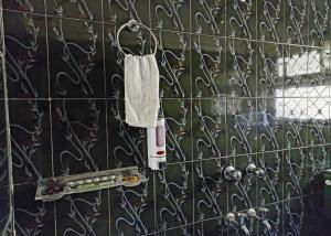 a white towel hanging on a tiled wall at Sunny Pines Resort in Lansdowne