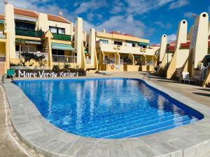 a swimming pool in front of a building at Cosy Mareverde FREE WIFI by Olax Rentals in Adeje