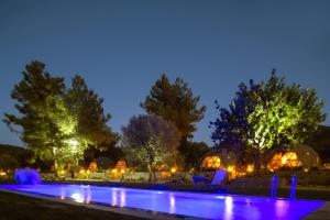 a swimming pool at night with lights at Lusso Glamping Bodrum in Bodrum City