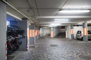 a parking lot with motorcycles parked in a parking garage at Adler Cavalieri Hotel-Private Spa & Gym in Florence