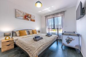 a bedroom with a large bed and a window at Apartment Rose in Medulin