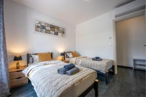 a bedroom with two beds and a window at Apartment Rose in Medulin