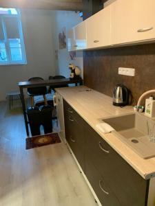 a kitchen with a sink and a counter top at Apartmán Charmant in Kroměříž