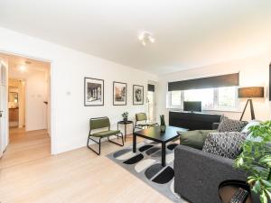 a living room with a couch and a table at Pass the Keys Chic apartment amazing location in Teddington