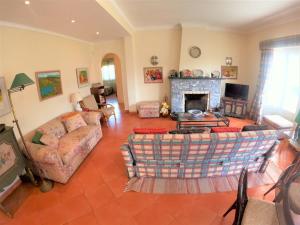 - un salon avec un canapé et une cheminée dans l'établissement Sintra V4 house with garden in Colares, à Colares